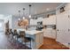 Bright kitchen featuring a large island with seating, pendant lighting, stainless steel appliances, and white cabinetry at 604 Airport Rd, Kannapolis, NC 28081
