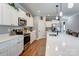 Bright, updated kitchen with white cabinetry, quartz countertops, and stainless steel appliances offers a modern cooking space at 604 Airport Rd, Kannapolis, NC 28081