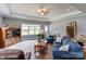 Well-lit living room with a comfortable blue sectional sofa, perfect for relaxing or entertaining guests at 604 Airport Rd, Kannapolis, NC 28081