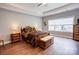 Comfortable primary bedroom with wooden flooring, a ceiling fan, an en-suite bathroom, and natural light at 604 Airport Rd, Kannapolis, NC 28081