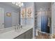 Updated bathroom with a marble countertop, soft gray vanity, and framed artwork at 657 Portside Dr, Davidson, NC 28036