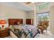 Cozy bedroom with a quilt-covered bed, a wooden dresser, and a sunlit window at 657 Portside Dr, Davidson, NC 28036