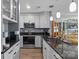 Modern kitchen with stainless steel appliances and dark granite countertops at 657 Portside Dr, Davidson, NC 28036