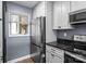 Updated kitchen features stainless steel appliances and white cabinets at 657 Portside Dr, Davidson, NC 28036