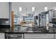 Modern kitchen featuring dark granite countertops and stainless steel dishwasher, seamlessly connecting to dining and living areas at 657 Portside Dr, Davidson, NC 28036