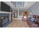 Cozy living room featuring a fireplace, wood floors, and views into the open-concept kitchen and dining area at 657 Portside Dr, Davidson, NC 28036