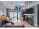 Bright living room with lake views, a fireplace, and a comfortable leather sofa at 657 Portside Dr, Davidson, NC 28036