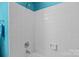 Clean, all-white tiled shower with a turquoise accent wall and modern fixtures at 657 Portside Dr, Davidson, NC 28036