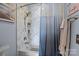 Stylish shower with marble-patterned tile surround, offering a spa-like experience at 657 Portside Dr, Davidson, NC 28036