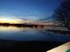 Scenic view of the lake at twilight with boats docked and lights reflecting on the calm water at 657 Portside Dr, Davidson, NC 28036
