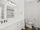 Elegant bathroom with a double vanity, marble countertops, and a glass-enclosed shower at 6647 Vlosi Dr, Charlotte, NC 28226