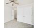 Bedroom featuring carpet, ceiling fan, and closet at 6647 Vlosi Dr, Charlotte, NC 28226