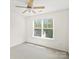 Bright bedroom with large window and ceiling fan at 6647 Vlosi Dr, Charlotte, NC 28226