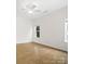 Bright bedroom with hardwood floors, ceiling fan and natural light from two large windows at 6647 Vlosi Dr, Charlotte, NC 28226