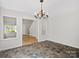 An open-concept dining room featuring hardwood floors, tile accents, and bright natural light at 6647 Vlosi Dr, Charlotte, NC 28226
