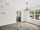 Dining room featuring decorative tile floors, chandelier, and large window at 6647 Vlosi Dr, Charlotte, NC 28226