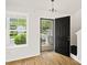 Inviting foyer featuring hardwood floors, natural light, and an open front door at 6647 Vlosi Dr, Charlotte, NC 28226