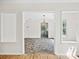 Open-concept living area with hardwood and tiled floors and natural light at 6647 Vlosi Dr, Charlotte, NC 28226