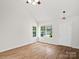 Cozy living room with natural light, wood floors, a ceiling fan, and inviting ambiance at 6647 Vlosi Dr, Charlotte, NC 28226