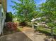 Landscaped backyard patio with white picket fence at 6647 Vlosi Dr, Charlotte, NC 28226