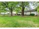 Spacious backyard features mature trees and a patio, creating a serene outdoor living space at 6718 Summerlin Pl, Charlotte, NC 28226