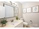 Bathroom featuring a vanity area, toilet and decorative wall art at 6718 Summerlin Pl, Charlotte, NC 28226