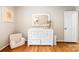 Bedroom room featuring a changing table, accent chair and a doorway to the hall at 6718 Summerlin Pl, Charlotte, NC 28226