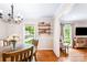 Dining room with stylish chandelier and view into the living room at 6718 Summerlin Pl, Charlotte, NC 28226