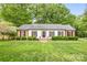 Charming one-story home with white siding, black shutters, and manicured landscaping at 6718 Summerlin Pl, Charlotte, NC 28226