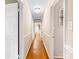 Hallway featuring hardwood floors and doors leading to other rooms at 6718 Summerlin Pl, Charlotte, NC 28226