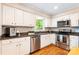 Updated kitchen with stainless steel appliances, granite counters, and white cabinets at 6718 Summerlin Pl, Charlotte, NC 28226