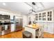 Kitchen with stainless appliances and kitchen island, featuring a built-in hutch at 6718 Summerlin Pl, Charlotte, NC 28226