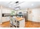 Bright eat-in kitchen with stainless appliances and a center kitchen island at 6718 Summerlin Pl, Charlotte, NC 28226