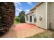 View of backyard patio surrounded by hedges, lawn, and beige siding at 6849 Blake Brook Dr, Concord, NC 28025
