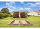 Backyard with trimmed bushes and stone firepit feature at 6849 Blake Brook Dr, Concord, NC 28025