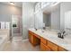 Bathroom boasts dual sinks, granite countertops, wood cabinets, tile flooring and backsplash, and lots of mirror space at 6849 Blake Brook Dr, Concord, NC 28025