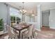 Dining room with a large window, chandelier, and a table set for six with elegant chairs at 6849 Blake Brook Dr, Concord, NC 28025