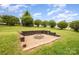 Landscaped backyard features a fire pit and level lawn at 6849 Blake Brook Dr, Concord, NC 28025