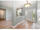 Welcoming foyer with hardwood floors, white trim, a front door with sidelights, and a large window at 6849 Blake Brook Dr, Concord, NC 28025