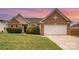 Traditional-style brick home with attached garage and manicured lawn at 6849 Blake Brook Dr, Concord, NC 28025
