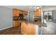 Updated eat-in kitchen with wood cabinets, granite countertops, tile backsplash, stainless appliances, and eat-in bar at 6849 Blake Brook Dr, Concord, NC 28025