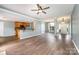 Open-concept living room with hardwood floors, ceiling fan, and a view of the kitchen and foyer at 6849 Blake Brook Dr, Concord, NC 28025