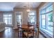 Cozy dining area with hardwood floors and large windows letting in natural light at 7409 Gilderstern Glen Ct, Huntersville, NC 28078