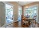 Sunlit dining area with hardwood floors and views of the screened-in porch at 7409 Gilderstern Glen Ct, Huntersville, NC 28078
