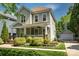 Charming two-story home with a well-manicured lawn and inviting front porch. Detached garage in the back at 7409 Gilderstern Glen Ct, Huntersville, NC 28078