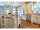Gourmet kitchen with a cooktop island, stainless steel appliances, and modern pendant lighting at 7409 Gilderstern Glen Ct, Huntersville, NC 28078