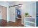 Open living room with hardwood floors, barn door, and a view of a cozy seating area at 7409 Gilderstern Glen Ct, Huntersville, NC 28078