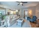 Open-concept living room with hardwood floors, an adjacent doorway to the entryway, and views into the kitchen at 7409 Gilderstern Glen Ct, Huntersville, NC 28078