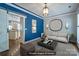 Cozy living room features a blue accent wall, neutral decor, and an adjacent doorway to the kitchen area at 7409 Gilderstern Glen Ct, Huntersville, NC 28078