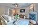 Cozy living room featuring a ceiling fan, fireplace, and an array of decor at 7409 Gilderstern Glen Ct, Huntersville, NC 28078